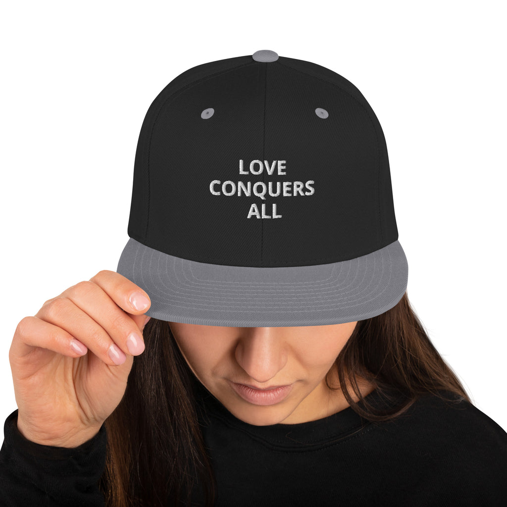 “Love conquers” Snapback Hat