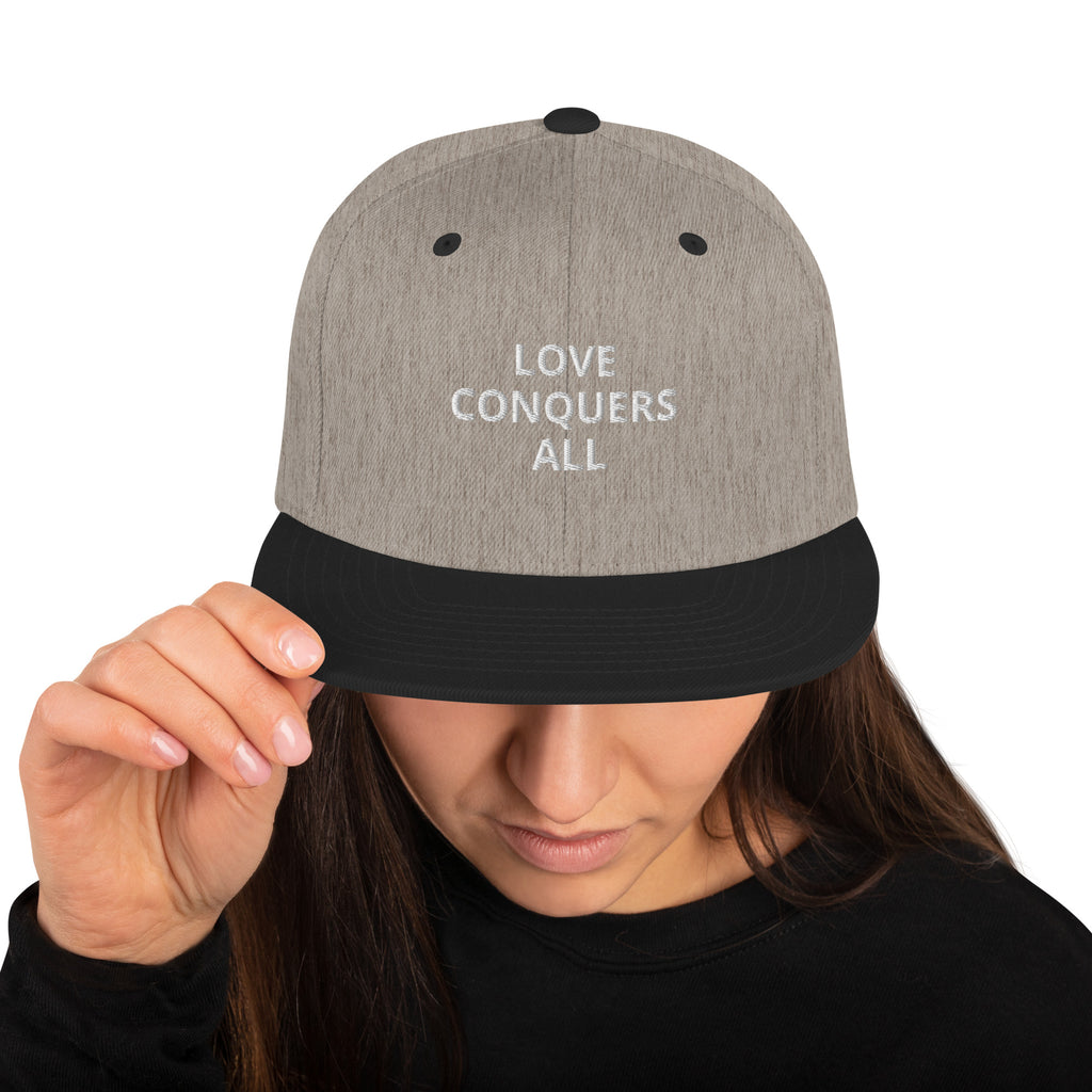 “Love conquers” Snapback Hat