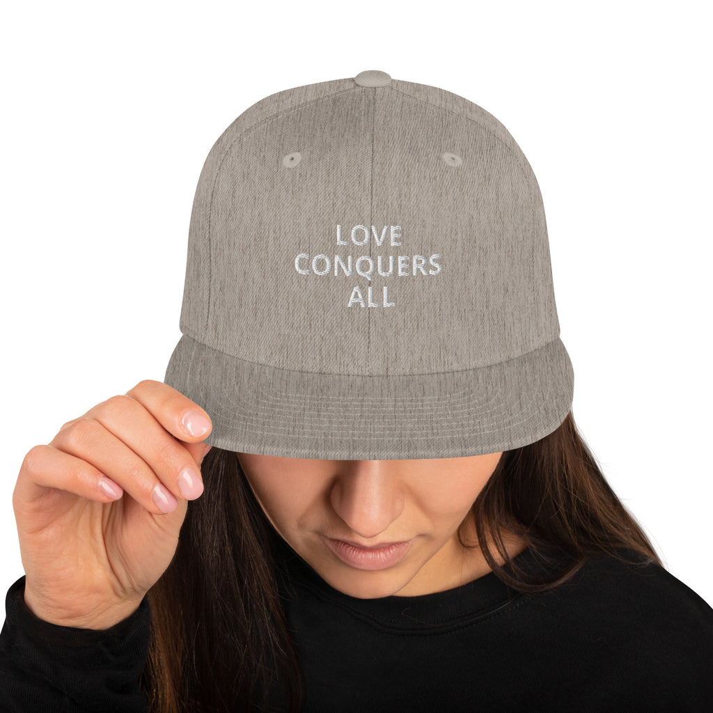 “Love conquers” Snapback Hat