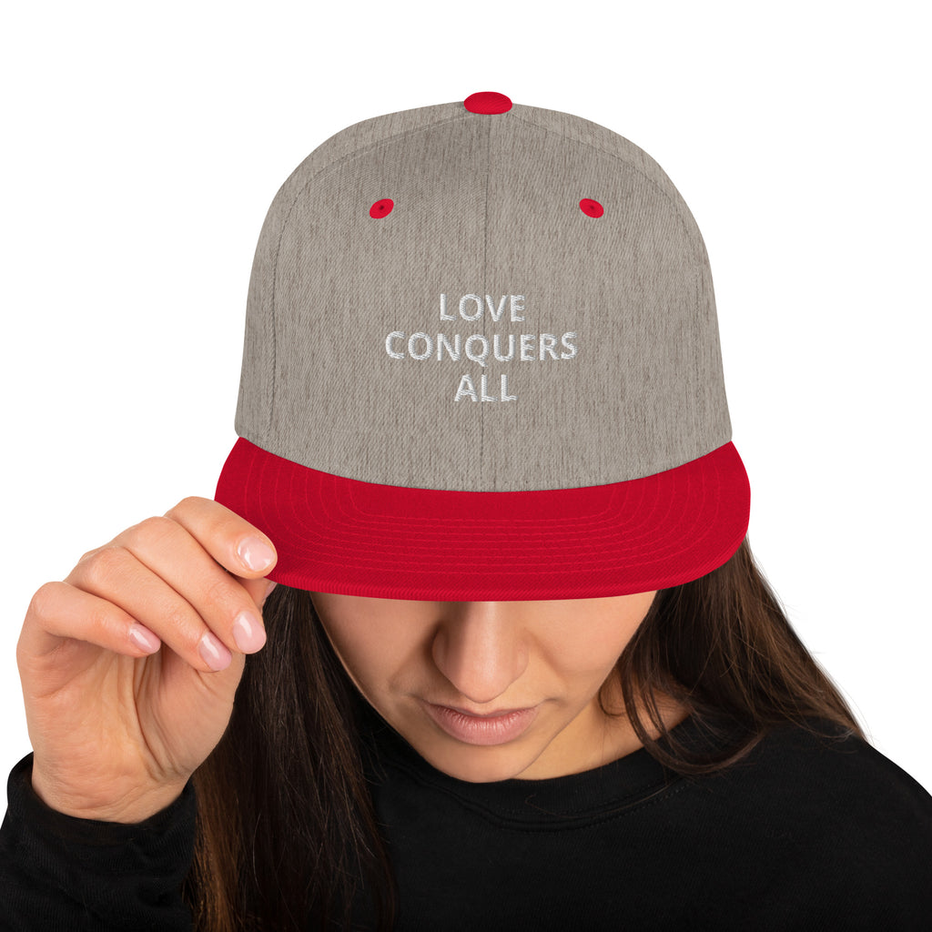 “Love conquers” Snapback Hat