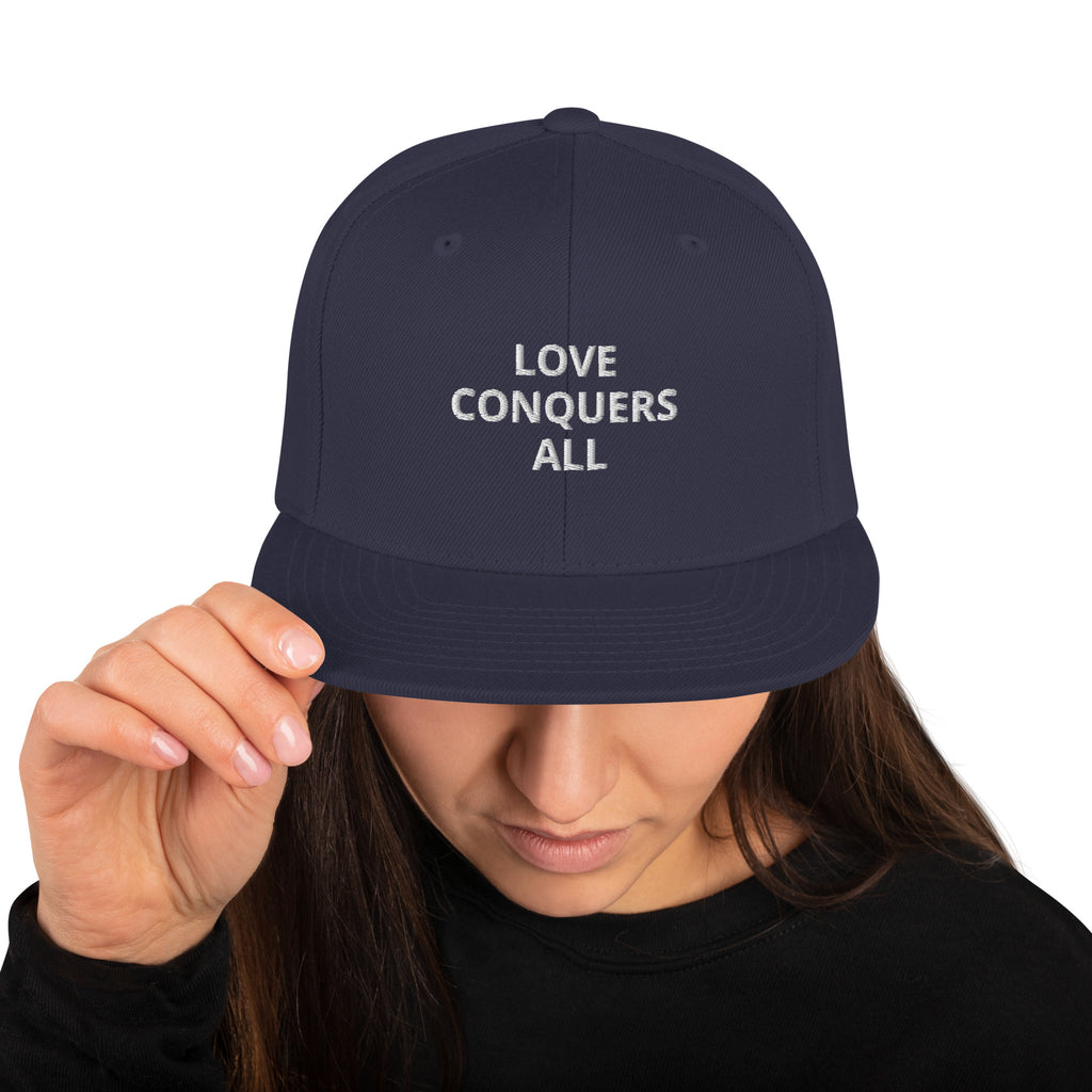 “Love conquers” Snapback Hat